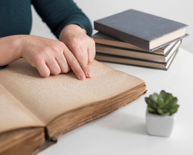 Close-up hands reading old book