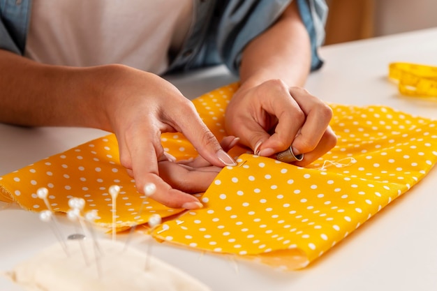 Close-up hands sewing fabric