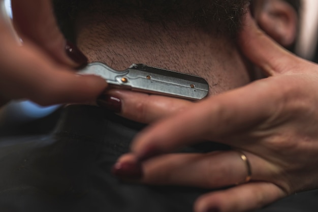 Close-up hands shaving neck