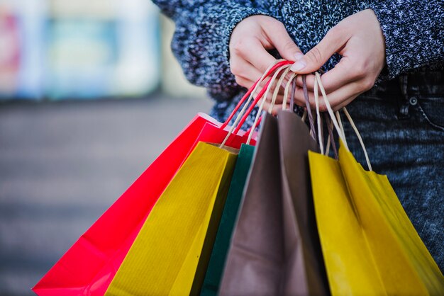close-up hands of shopper with bags