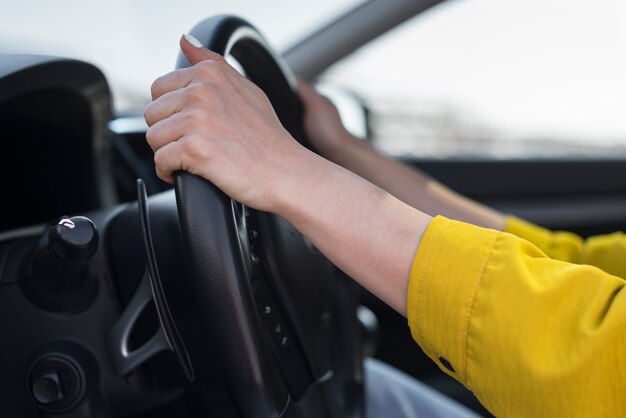 Close-up hands on the steering wheel