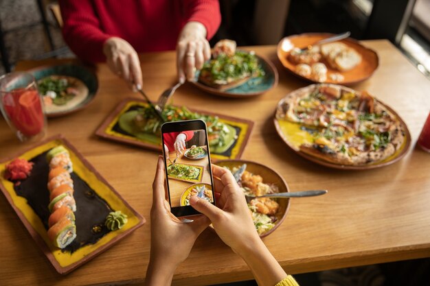 Close up hands taking food photos