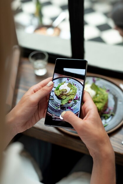 Close up hands taking food photos