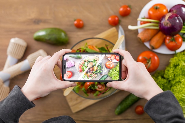 Free photo close up hands taking photo of food