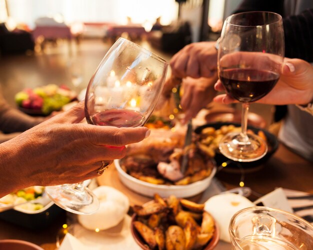 Close-up hands toasting glasses