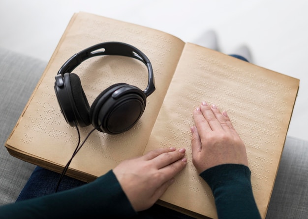 Free photo close-up hands touching braille book