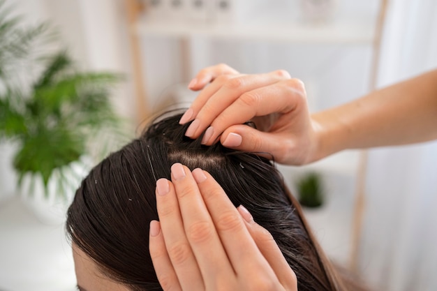 Close up hands treating dandruff