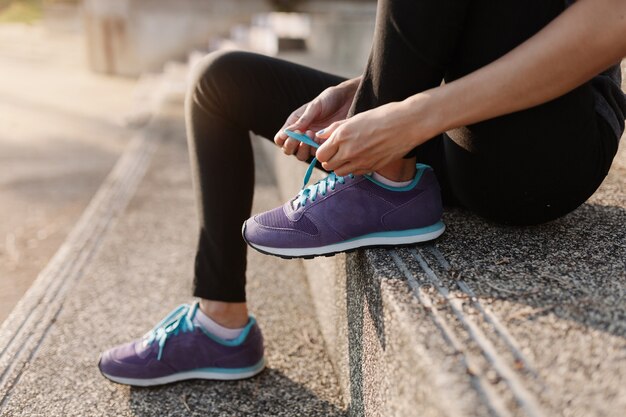 Close-up of hands tying laces