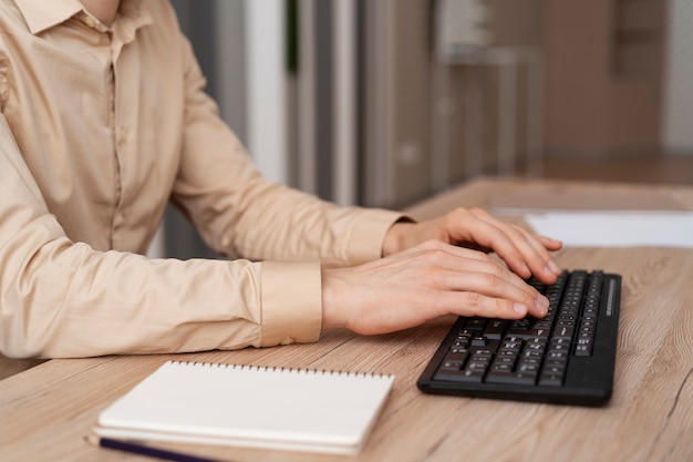 Free photo close up hands typing on keyboard