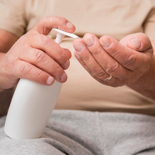 Close-up hands using disinfectant