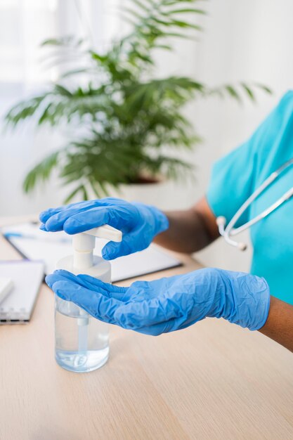 Close-up hands using disinfectant