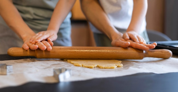 Close-up hands using rolling pin