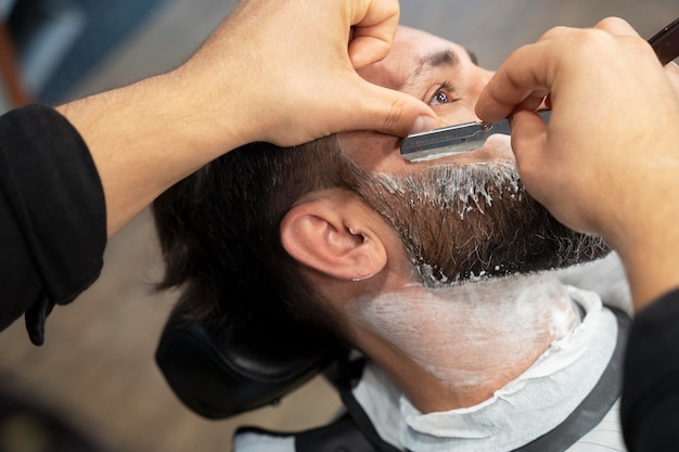 Close up hands using shaving blade