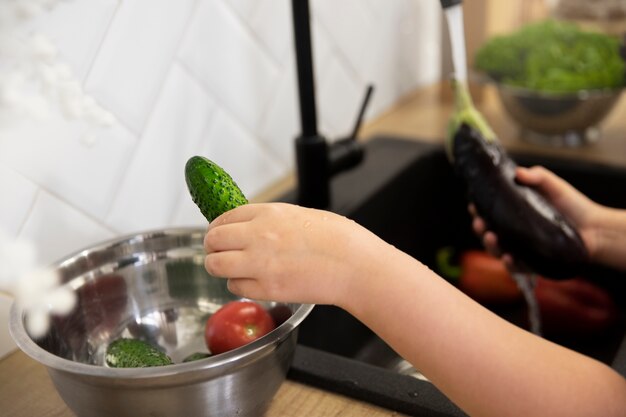 Close up hands washing vegetables