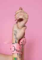 Free photo close up hands wearing pink handcuffs