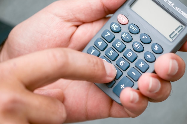 Close-up of hands with calculator