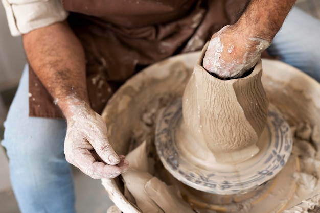 Close up hands with clay