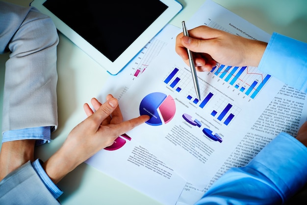 Free photo close-up of hands with financial charts at business meeting