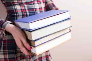 Free photo close-up of hands with four thick books