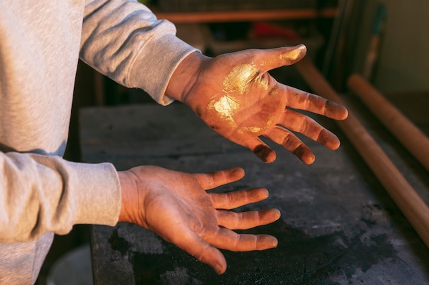 Close-up hands with golden glitter