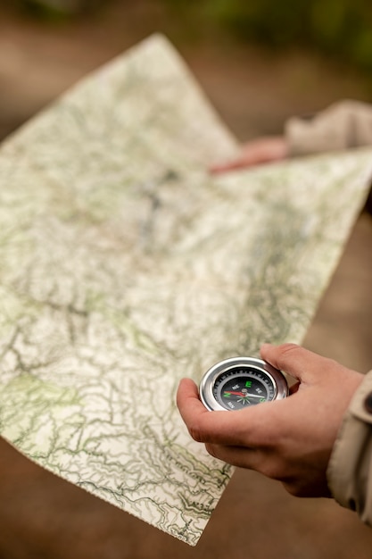 Close-up hands with map and compass