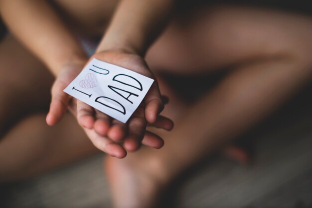 Close-up of hands with a note for father's day