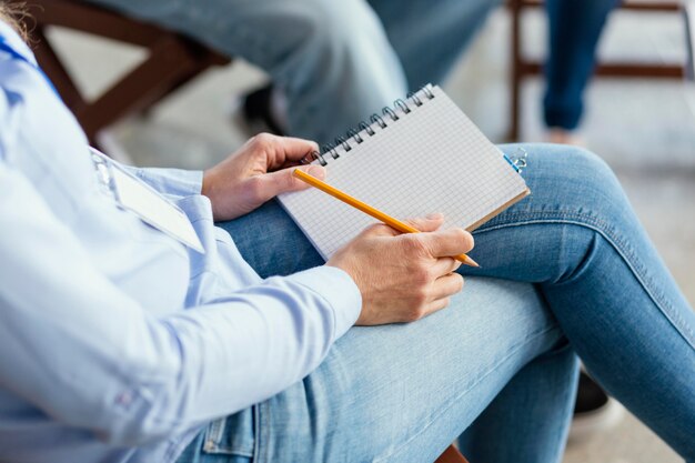 Close up hands with notebook and pencil