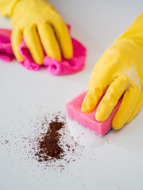 Close-up hands with rubber gloves disinfecting