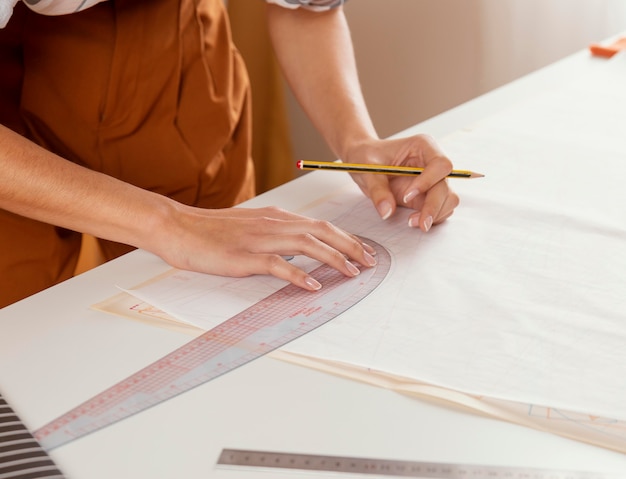 Close-up hands with ruler and pencil