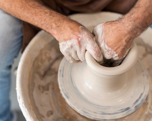 Close up hands working with clay