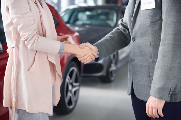 Close up of handshake salesman and woman