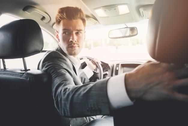 Close-up of handsome man driving reverse