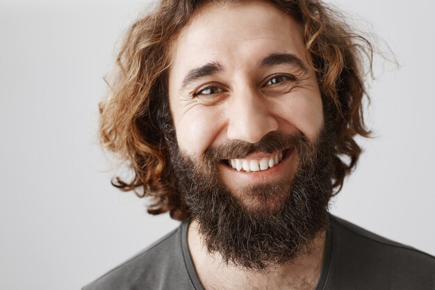 Close-up of handsome smiling bearded middle-eastern man happy