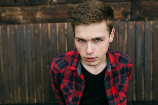 Free photo close-up of handsome teenager wearing a plaid shirt