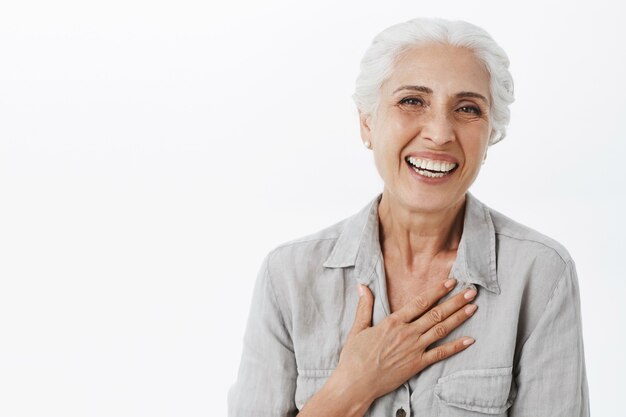 Close-up of happy adorable old lady laughing and smiling