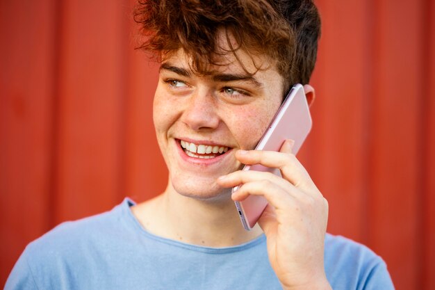 Close-up happy boy talking on the phone