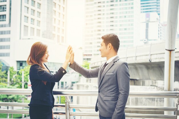 Close up of Happy Business people Showing High Five Sign with team outside.