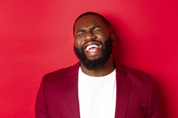 Close-up of happy and carefree Black man having fun, laughing and smiling