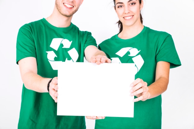 Close-up of a happy couple holding blank white placard