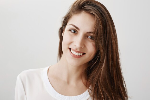 Close-up of happy gorgeous healthy woman smiling at front