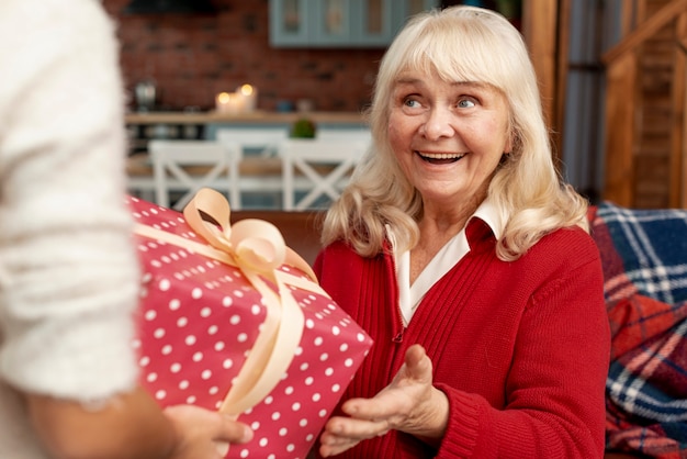 Close-up happy grandmother receiving a gift