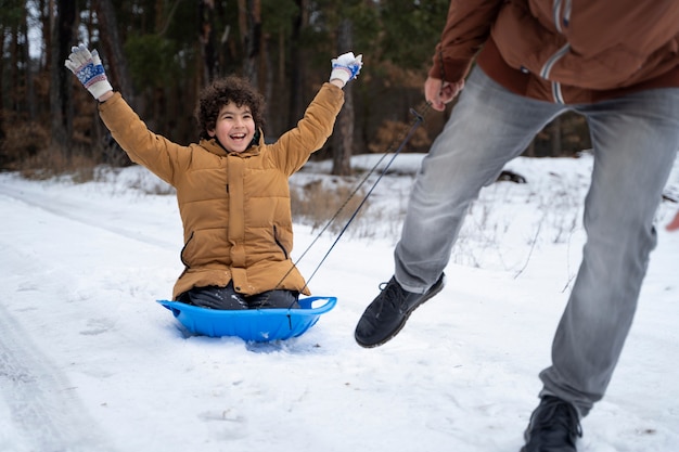 Close up happy kid having fun winter time