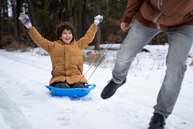 Close up happy kid having fun winter time