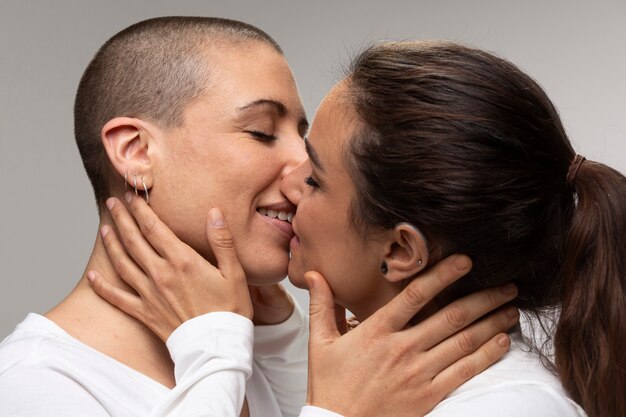 Close up happy lesbians kissing