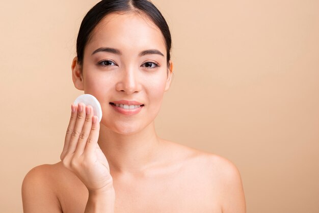 Close-up happy model with cotton pads