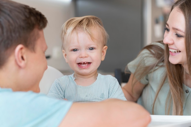 Крупным планом счастливые родители с улыбающимся малышом