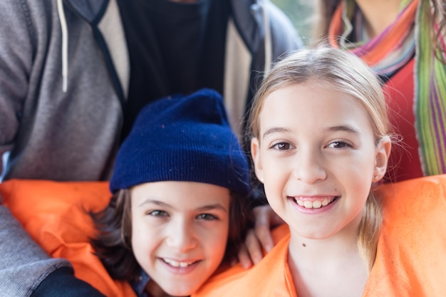 Close-up of happy siblings with life jackets