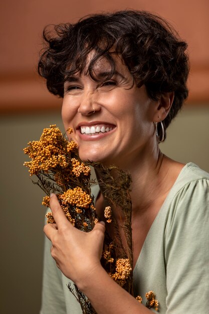 Close up happy woman holding flowers