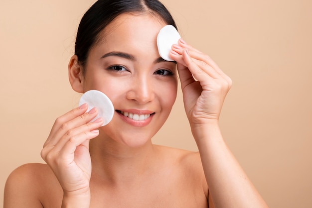 Close-up happy woman with cotton pads