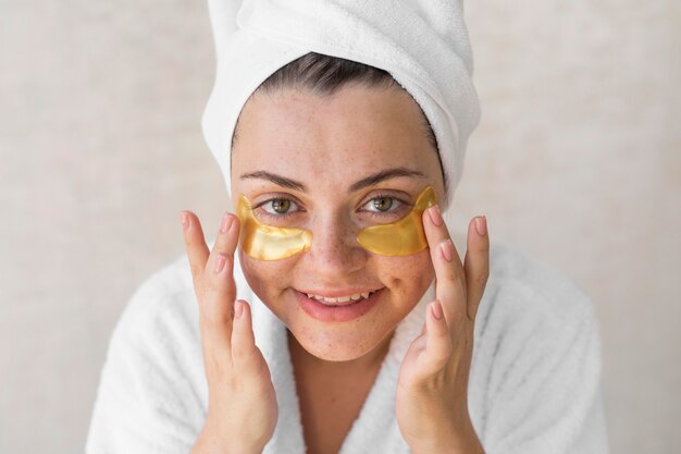 Close-up happy woman with eye patches